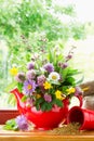 Teapot with bouquet of healing herbs and flowers