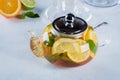 Teapot of Citrus tea with mint on blue stone table. Still life. Drink Healthcare Cold Concept Royalty Free Stock Photo