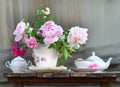 Teapot, cup and beautiful spring bouquet