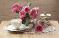 Teapot, cup and beautiful spring bouquet