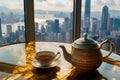 teapot and cup set on a table with a window overlooking the city