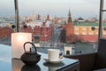 Teapot with a cup on the table in cozy cafe with