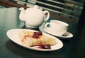 Teapot, cup of tea and pancakes with cherry confiture Royalty Free Stock Photo