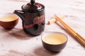 Teapot and cups of green tea on a white wooden background Royalty Free Stock Photo