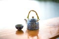 Teapot and cups on table in the sunrise Royalty Free Stock Photo