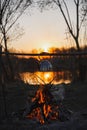 Teapot on the fire prepares tea. Orange sunset Royalty Free Stock Photo