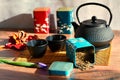 Teapot with loose green tea leaves with cups and bamboo mat Royalty Free Stock Photo