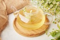 Teapot natural organic herbal linden chamomile tea. Healthy table setting, warm beverage