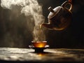 A teapot pouring tea into a cup on a table Royalty Free Stock Photo