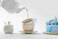teapot pouring tea in cups near blue cake Royalty Free Stock Photo