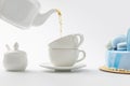 teapot pouring tea in cups near blue cake Royalty Free Stock Photo