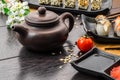 Teapot and sushi set sashimi and sushi rolls on dark background Royalty Free Stock Photo