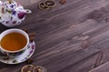 Teapot tea cup on brown wooden table.