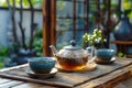 A teapot and two cups sit on a wooden tray Royalty Free Stock Photo