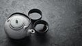 Teapot and two cups of tea on a black stone background. Top view. Royalty Free Stock Photo