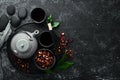 Teapot and two cups of tea on a black stone background. Top view. Royalty Free Stock Photo