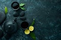 Teapot and two cups of tea on a black stone background. Top view. Royalty Free Stock Photo