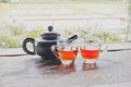 A teapot and two tea cups on a wooden floor with a rice field view Royalty Free Stock Photo