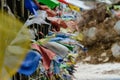Tear colorful Tibetan prayer flags waving and swaddled with bridge over frozen river at Thangu and Chopta valley in winter. Royalty Free Stock Photo
