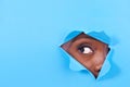 Tear, hole and eye of person on blue background for vision, eyesight and looking for inspiration. Mockup space, creative Royalty Free Stock Photo