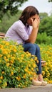 Tearful Female Sitting In Park