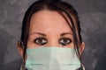 Tearful woman - medical worker - with blurry eyes and mask. Doctor or nurse helping patients with covid-19.