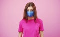 Tearful woman wearing facemask, isolated