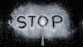 Teaspoon sugar and stop text on sugar isolated on black background Royalty Free Stock Photo