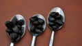 Teaspoons and dark seeds Royalty Free Stock Photo