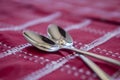 Teaspoons on a red tablecloth