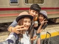 Travel concept.group of traveller friend take photo with train background.asia tourist feel happy in terminal at Hualumpong Royalty Free Stock Photo