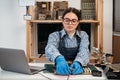 Tech fixes motherboard in service center. Female repairman working with computer with a part in hands. Monitors and Royalty Free Stock Photo