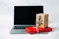 Tech gifts for Christmas for the tech-obsessed person. Gadgets and devices Xmas gift ideas. Laptop with Christmas Gift