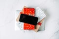 Tech gifts for Christmas for the tech-obsessed person. Laptop, keyboard and smartphone with Christmas Gift boxes on the