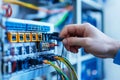In a tech lab, a networking professional carefully adjusts networking cables and routers, ensuring optimal connectivity Royalty Free Stock Photo