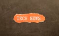 TECH NEWS written on sticky note paper over a kork board. Business concept for newly received Royalty Free Stock Photo