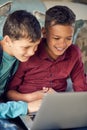 The tech savvy generation. a two young boys using a laptop together at home. Royalty Free Stock Photo