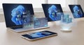 A tech setup features multiple laptops and a smartphone on a wooden table, Royalty Free Stock Photo