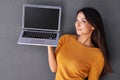 Tech that suits my needs. Portrait of an attractive young woman holding up a laptop with a blank screen. Royalty Free Stock Photo