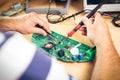 Tech tests electronic equipment in service center Royalty Free Stock Photo