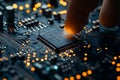 In a tech workshop, the process of assembly is underway, with a close-up view of a finger placing a chip onto a Royalty Free Stock Photo