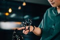 At a technical college a teen boy tests a robot hand and arm touching fingers Royalty Free Stock Photo