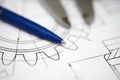 Technical drawing lays on a workspace with a blue pen and tools nearby in a detailed design environment Royalty Free Stock Photo