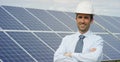 Technical expert in solar energy photovoltaic panels, remote control performs routine actions for system monitoring using clean, r Royalty Free Stock Photo