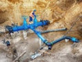 Technical open gate valve on drink water pipes joined with new black waga multi joint members into old pipeline system. Royalty Free Stock Photo