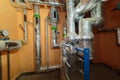 Technical pipes for sewerage in the basement of a building with pressure gauges. Insulated pipe system