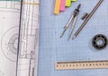 Technical project drawing above graph paper with engineering tools. Royalty Free Stock Photo