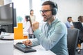 Technical support operator working with headset in call center office Royalty Free Stock Photo