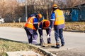 Technical utility workers carry out maintenance in the sewer manhole