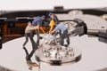 Technicial team miniature people repairing hard drive Royalty Free Stock Photo